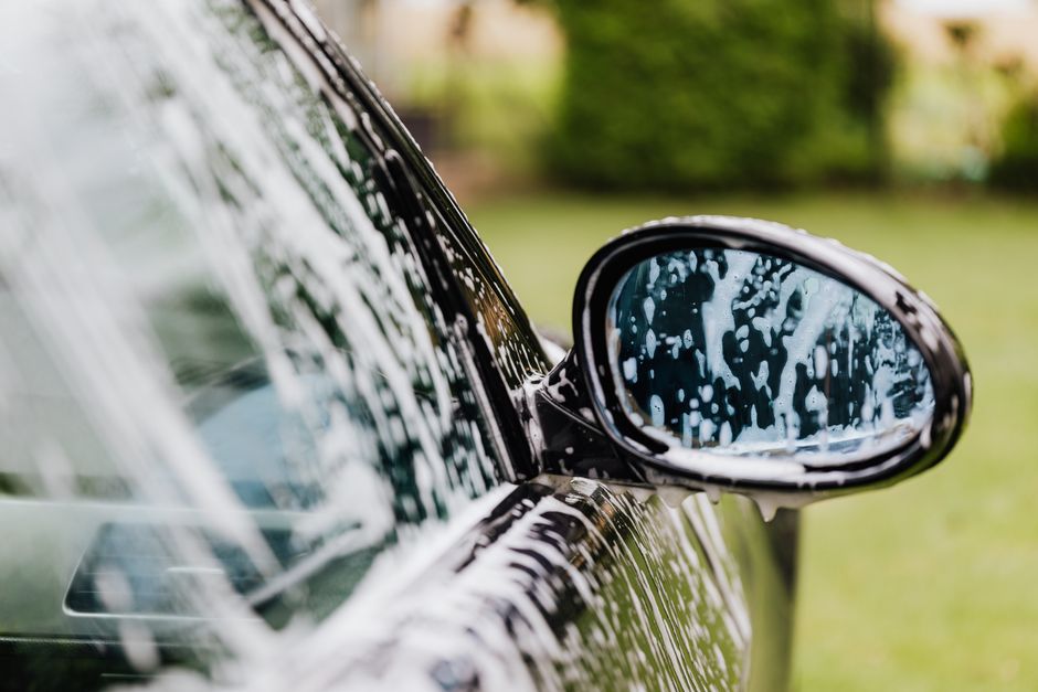Thick foam application during a premium car wash and paint correction process